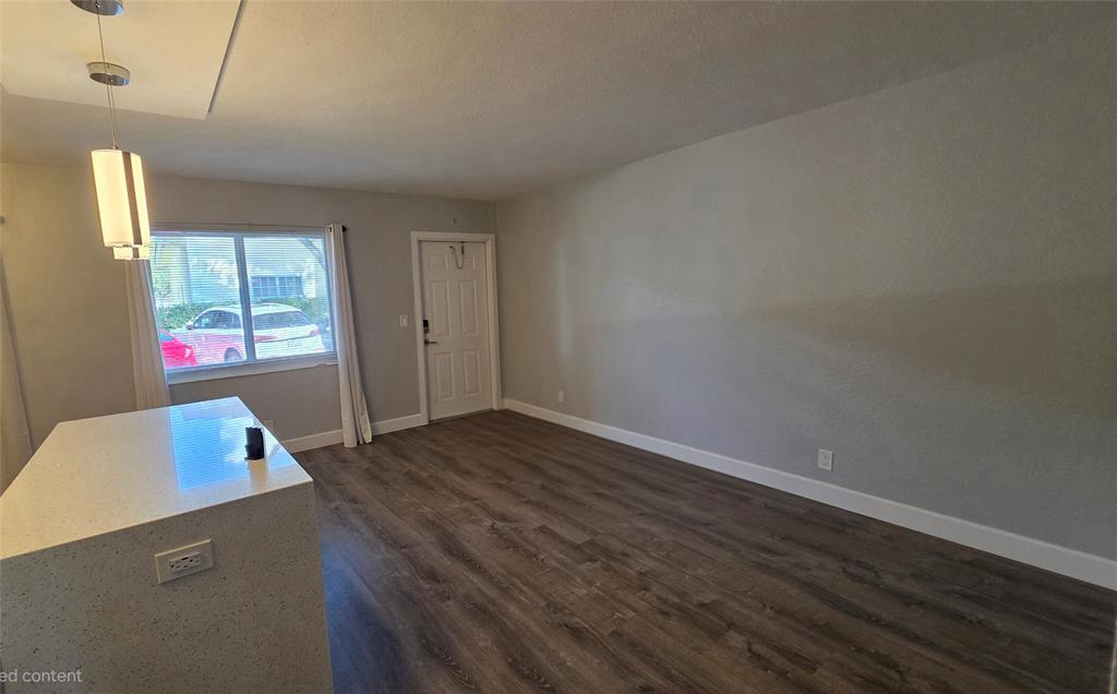 2607 Northeast 8th Avenue, Unit 14 Wilton Manors, FL 33334 - Photo 7 of 12 an empty room with wooden floor and windows