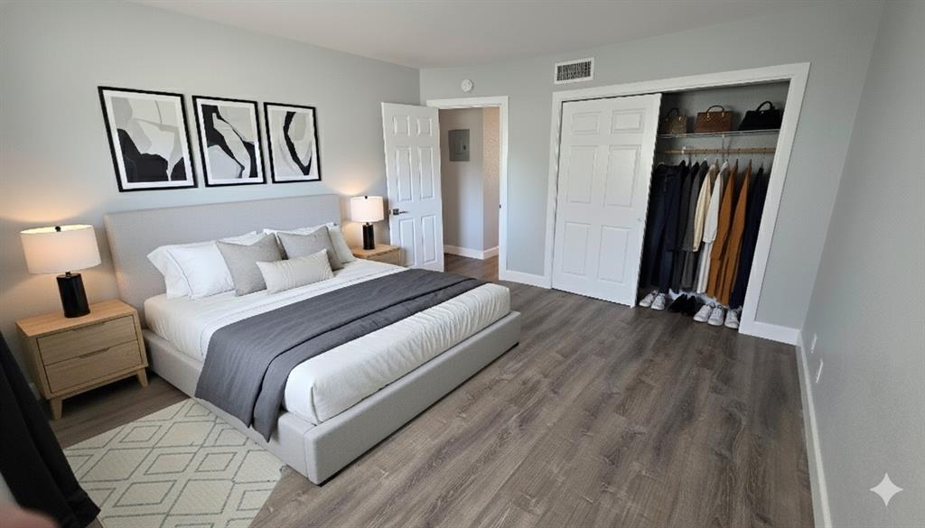 2607 Northeast 8th Avenue, Unit 14 Wilton Manors, FL 33334 - Photo 8 of 12 a bedroom with a bed and a painting on the wall