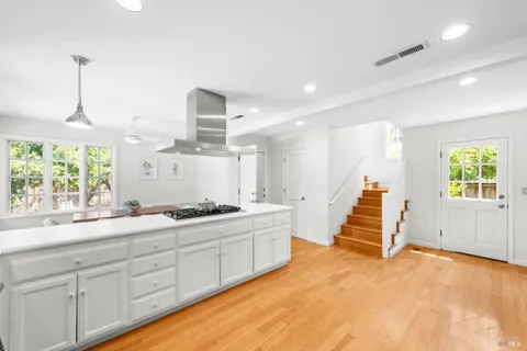 a view of a kitchen with a sink and windows