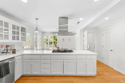 a kitchen with a sink stove and cabinets