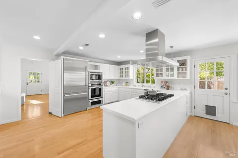 a kitchen with a sink appliances and cabinets
