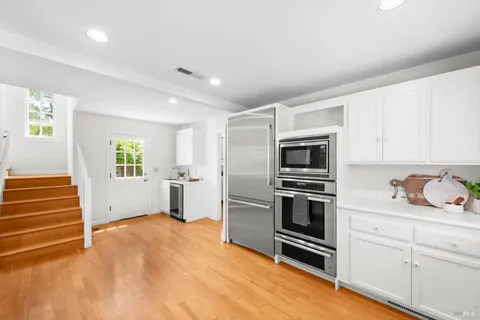 a kitchen with granite countertop stainless steel appliances and counter space