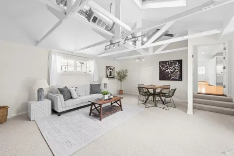 a living room with furniture and white walls