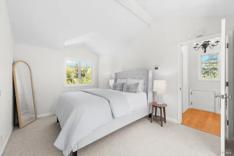 a bedroom with a bed and a lamp on table