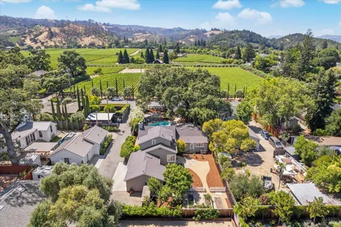 an aerial view of residential houses with outdoor space and street view