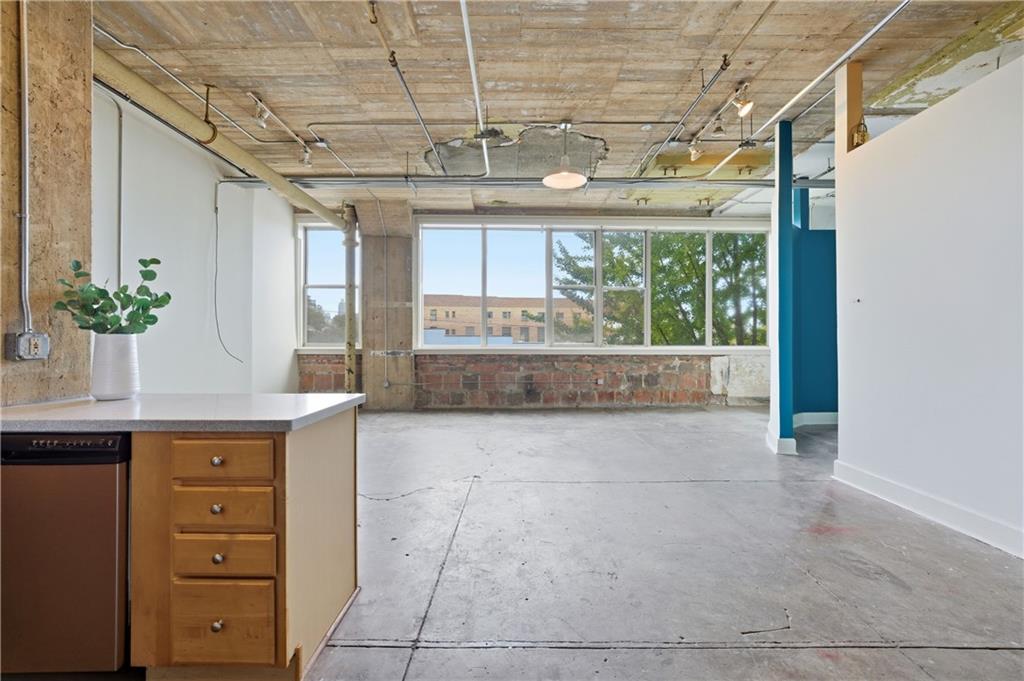 a large white kitchen with a large window