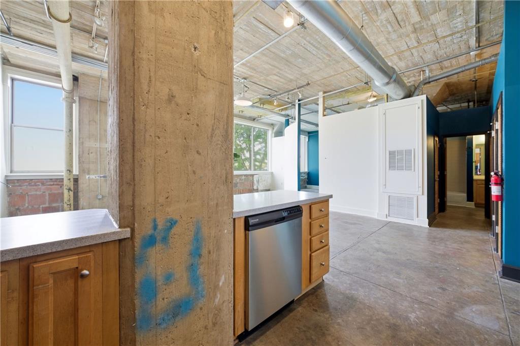 505 Whitehall Street Southwest, Unit 203 Atlanta, GA 30303 - Photo 12 of 36 a kitchen with stainless steel appliances granite countertop a sink and a refrigerator