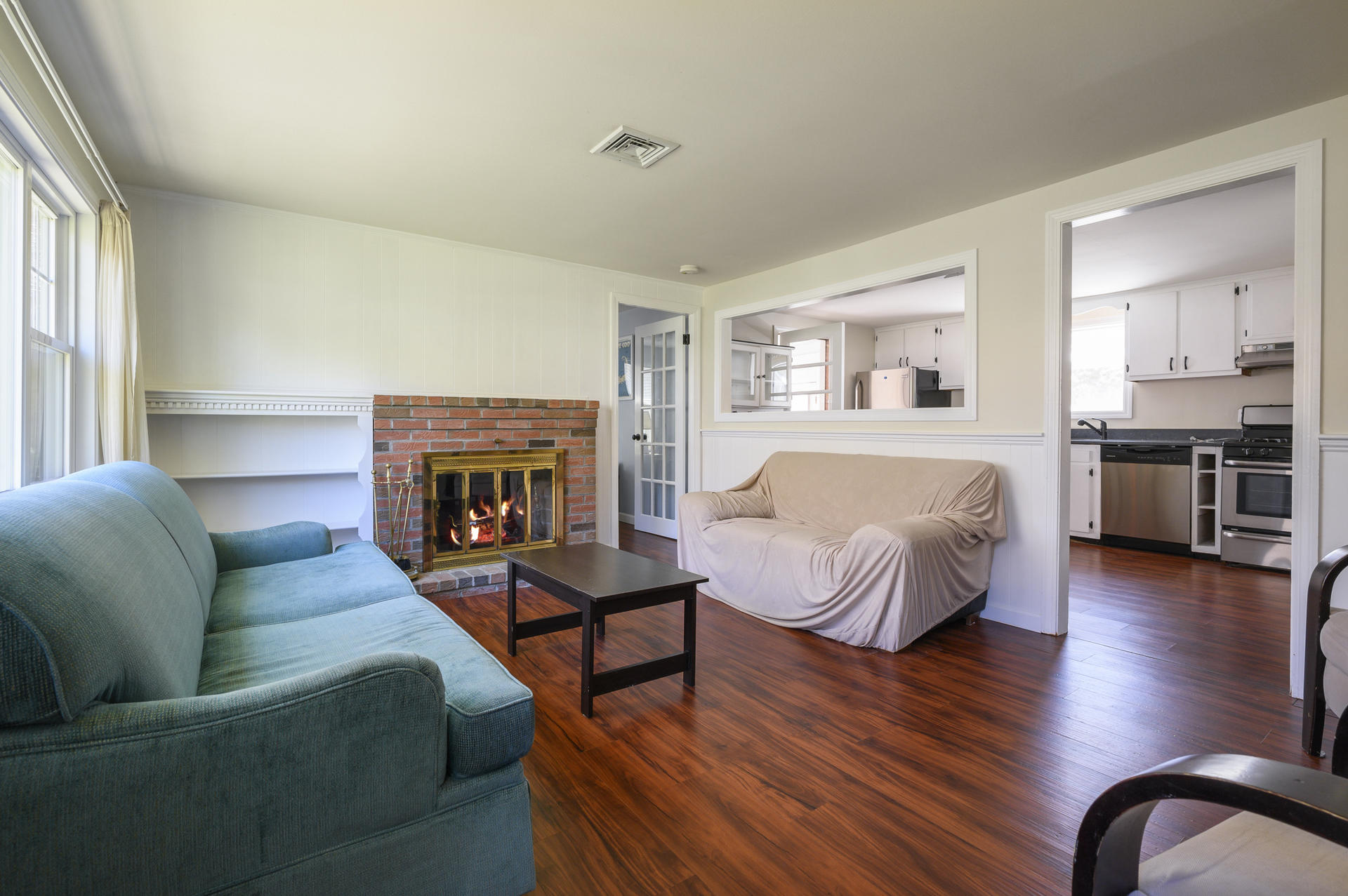 17 Farm Hill Road Centerville, MA 02632 - Photo 3 of 25 a spacious bedroom with a bed couch and a fireplace