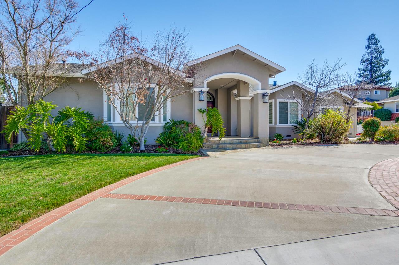 a front view of a house with garden