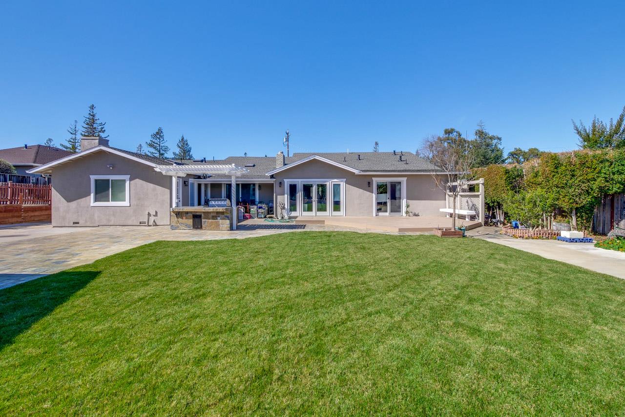 21972 McClellan Road Cupertino, CA 95014 - Photo 11 of 15 a front view of a house with a yard table and chairs