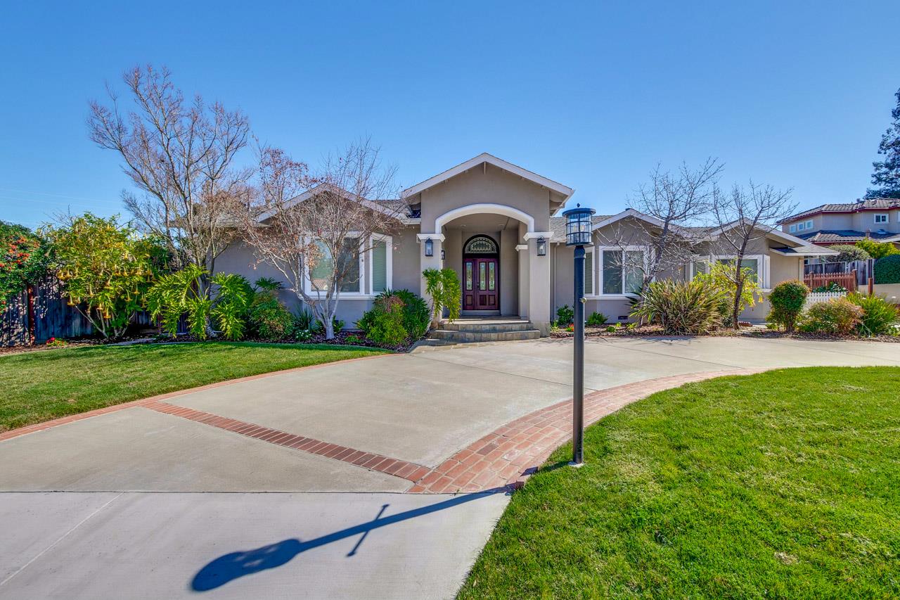 21972 McClellan Road Cupertino, CA 95014 - Photo 3 of 15 a front view of a house with a yard and trees