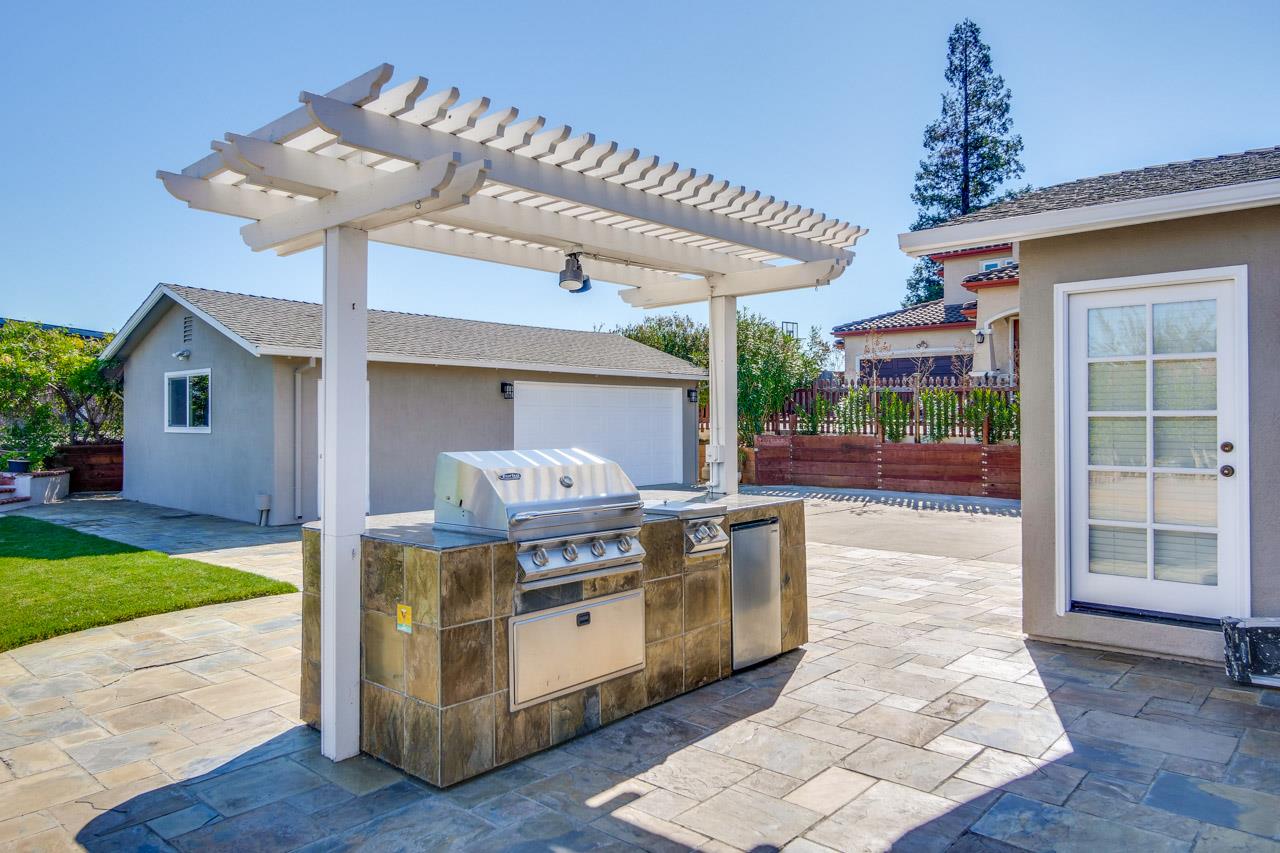 21972 McClellan Road Cupertino, CA 95014 - Photo 9 of 15 a living room filled with furniture and a chandelier