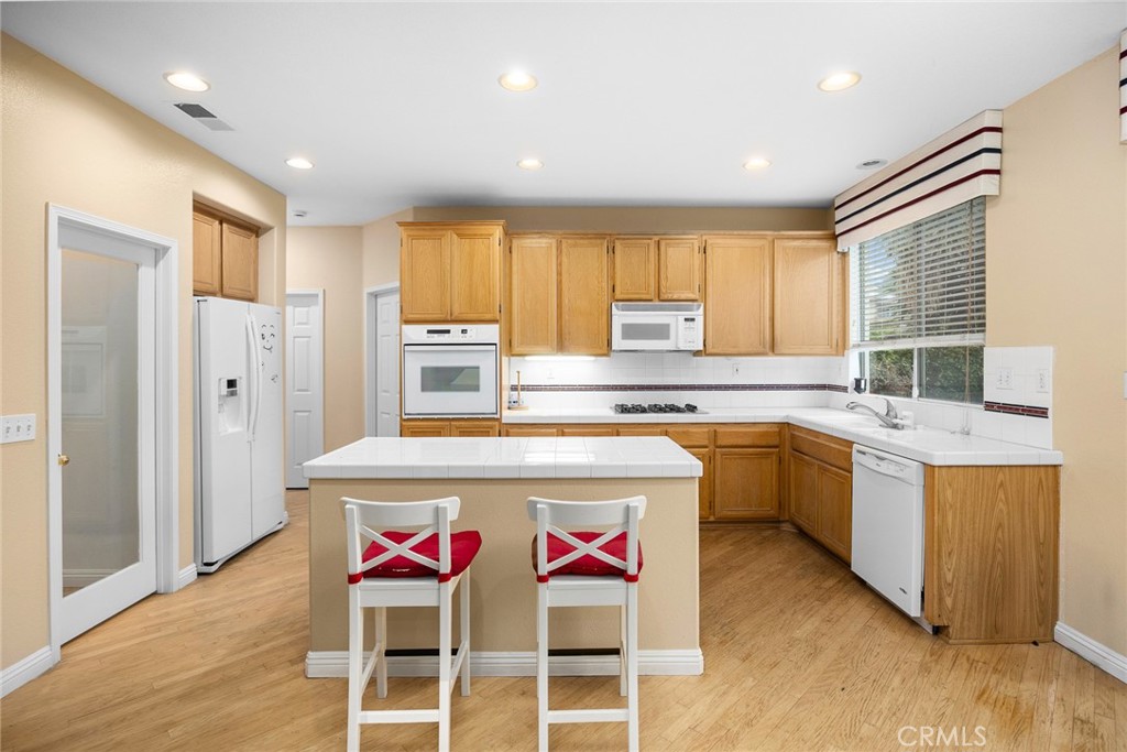 7343 Legacy Place Rancho Cucamonga, CA 91730 - Photo 14 of 53 a kitchen with stainless steel appliances granite countertop a stove a sink dishwasher and a refrigerator