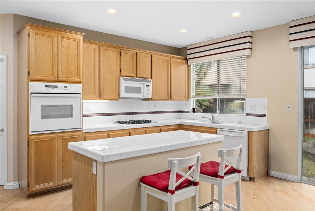 7343 Legacy Place Rancho Cucamonga, CA 91730 - Photo 15 of 53 a kitchen with a stove a sink and a refrigerator