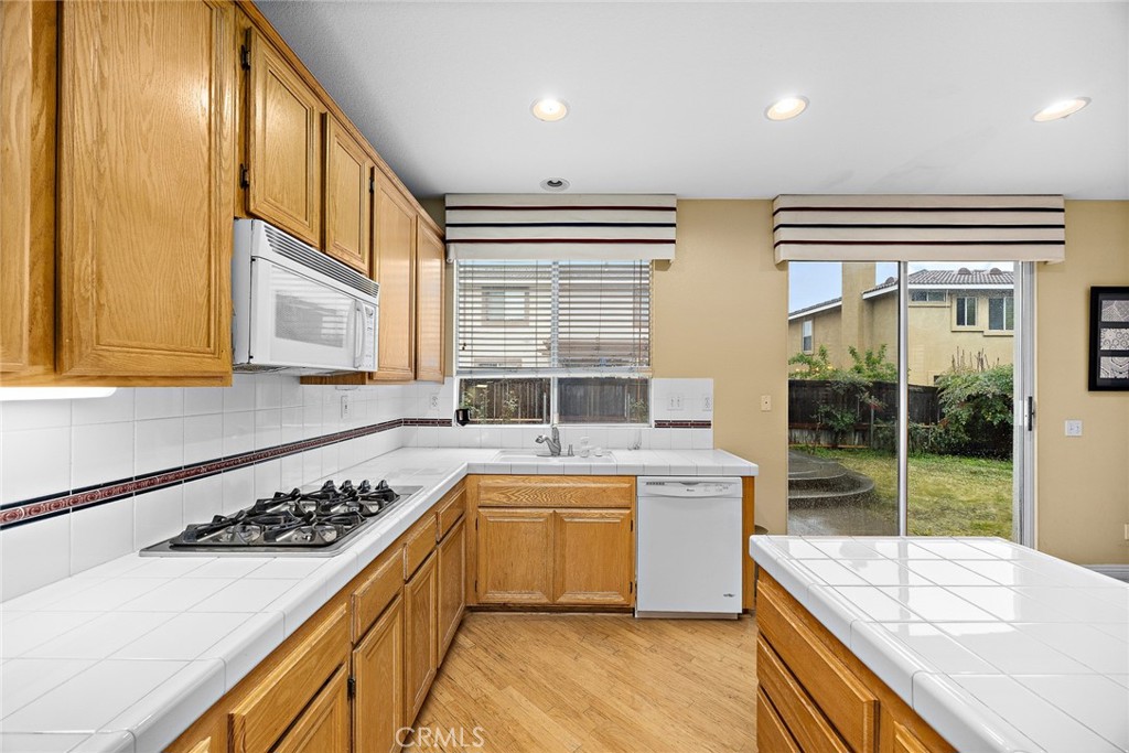 7343 Legacy Place Rancho Cucamonga, CA 91730 - Photo 17 of 53 a kitchen with a sink stove and cabinets