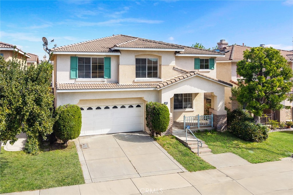 7343 Legacy Place Rancho Cucamonga, CA 91730 - Photo 2 of 53 a front view of a house with a yard and potted plants
