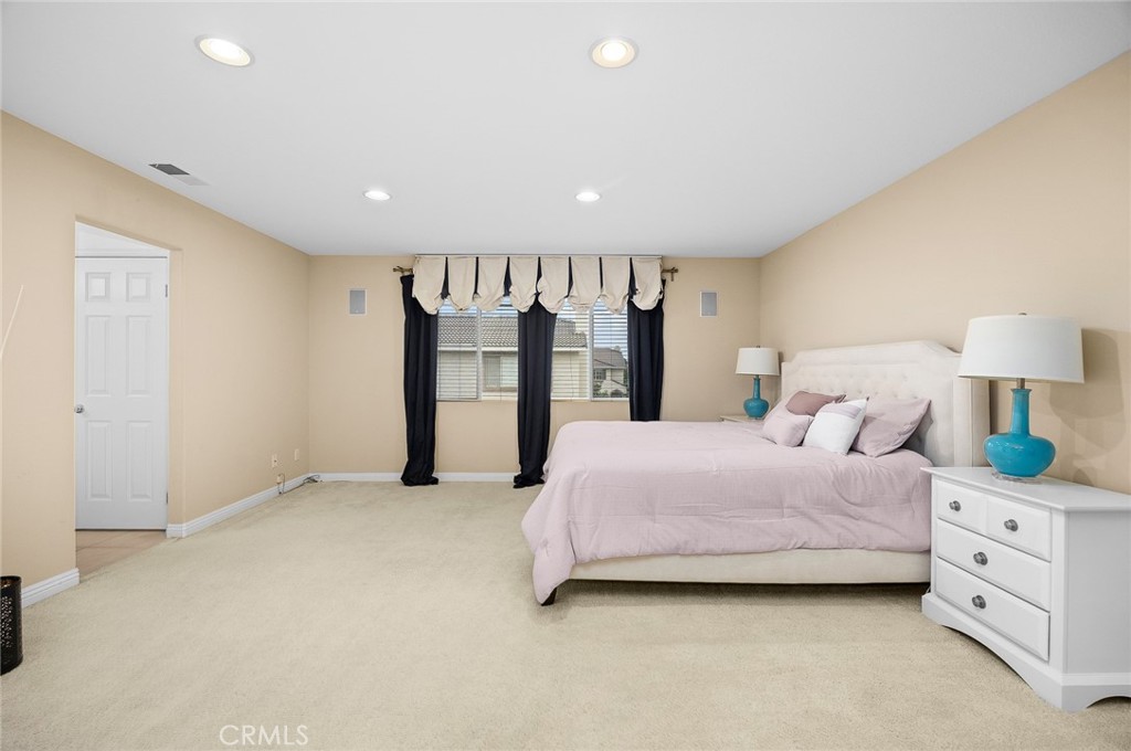 7343 Legacy Place Rancho Cucamonga, CA 91730 - Photo 25 of 53 a spacious bedroom with a bed and a walk in closet