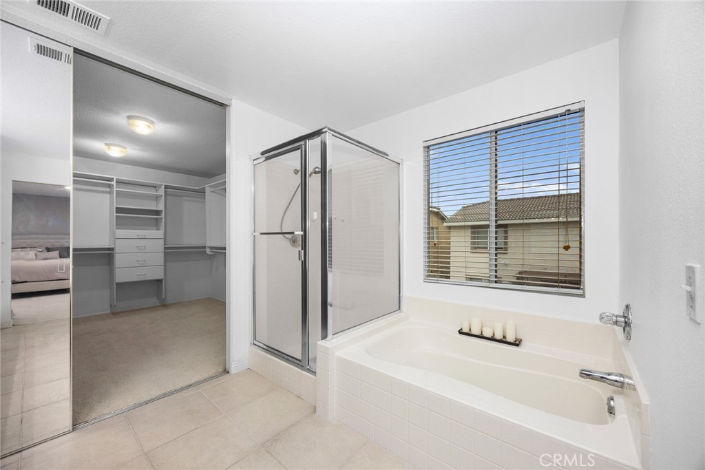 7343 Legacy Place Rancho Cucamonga, CA 91730 - Photo 28 of 53 a bathroom with a bathtub and a shower
