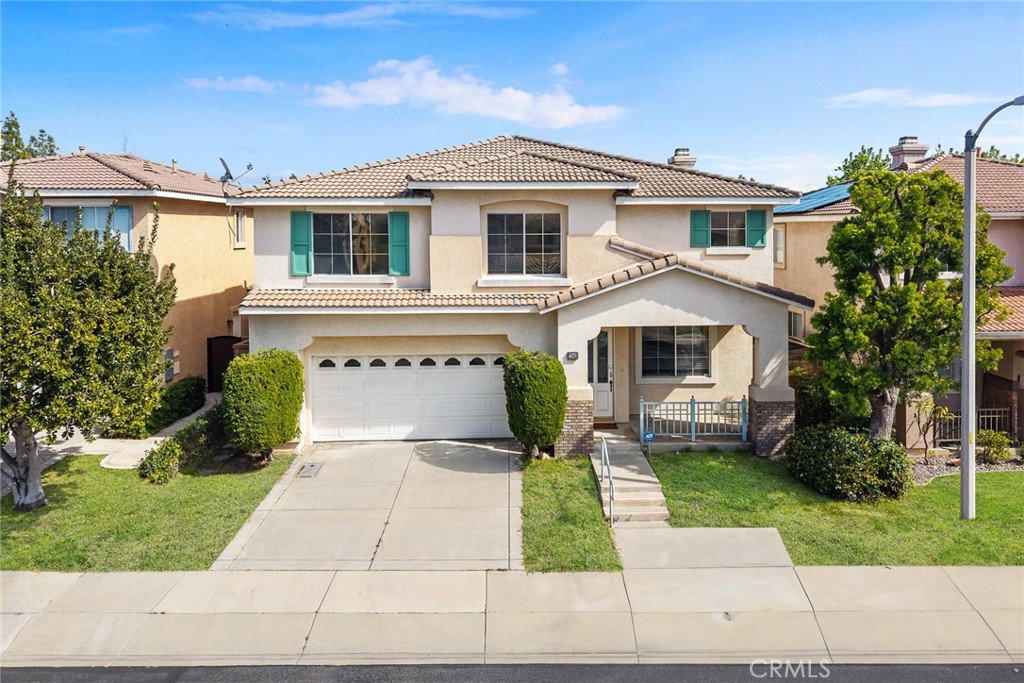 7343 Legacy Place Rancho Cucamonga, CA 91730 - Photo 3 of 53 a front view of a house with a yard