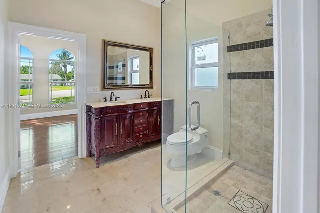 a spacious bathroom with a bathtub sink mirror vanity and toilet