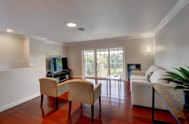 a view of a livingroom with furniture window and wooden floor