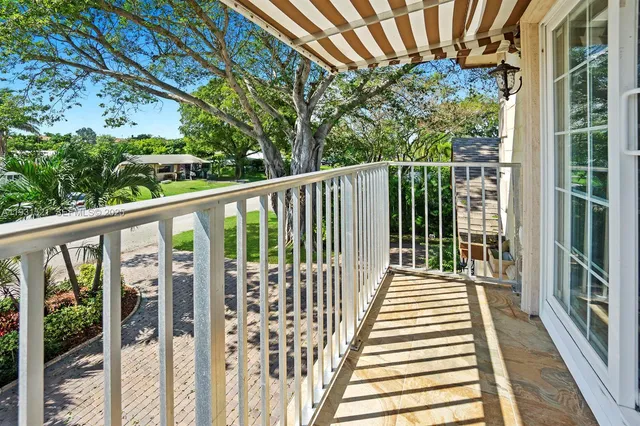 a view of a balcony with wooden floor