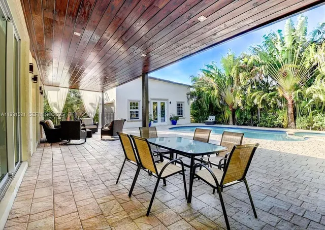 a view of a patio with a table and chairs