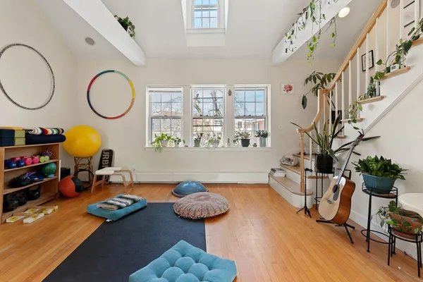 a living room with furniture a chandelier and a wooden floor