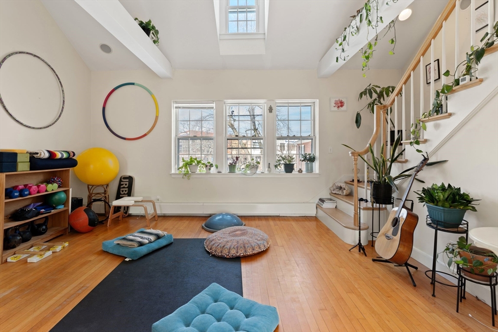 76 Boylston Street, Unit 4 Newton, MA 02467 - Photo 2 of 14 a living room with furniture a chandelier and a wooden floor