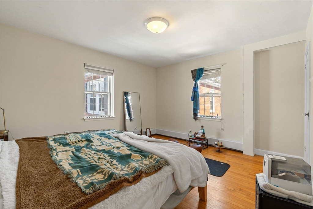76 Boylston Street, Unit 4 Newton, MA 02467 - Photo 7 of 14 a bedroom with a bed and a window