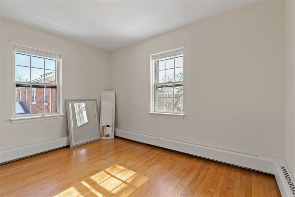 76 Boylston Street, Unit 4 Newton, MA 02467 - Photo 8 of 14 an empty room with windows