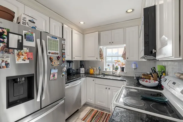 a kitchen with stainless steel appliances a refrigerator sink and cabinets