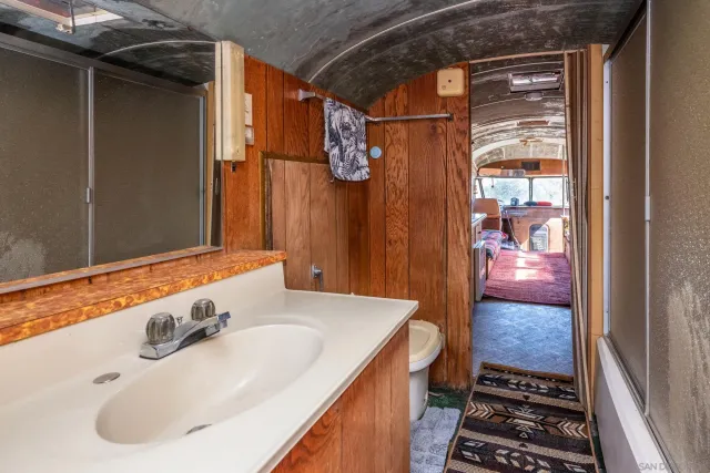 a bathroom with a toilet a sink and mirror