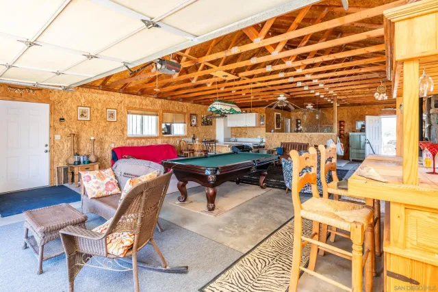 a view of a dry yard with wooden fence