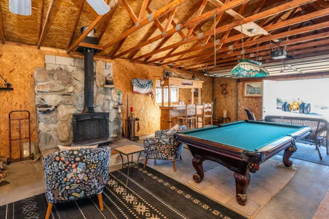 an aerial view of house with yard and mountain view in back