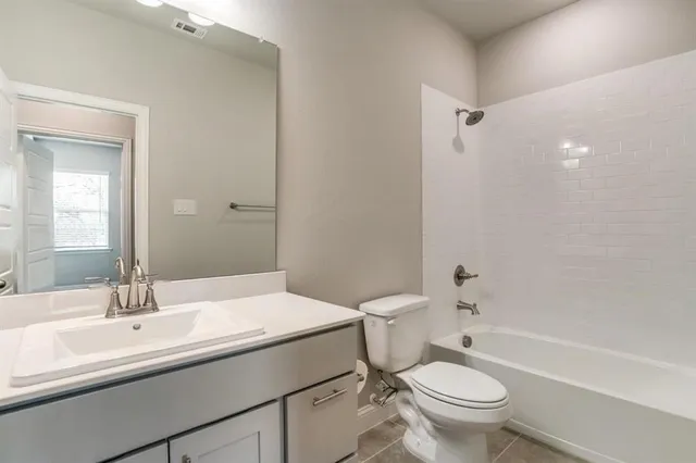 a bathroom with a sink toilet vanity and shower