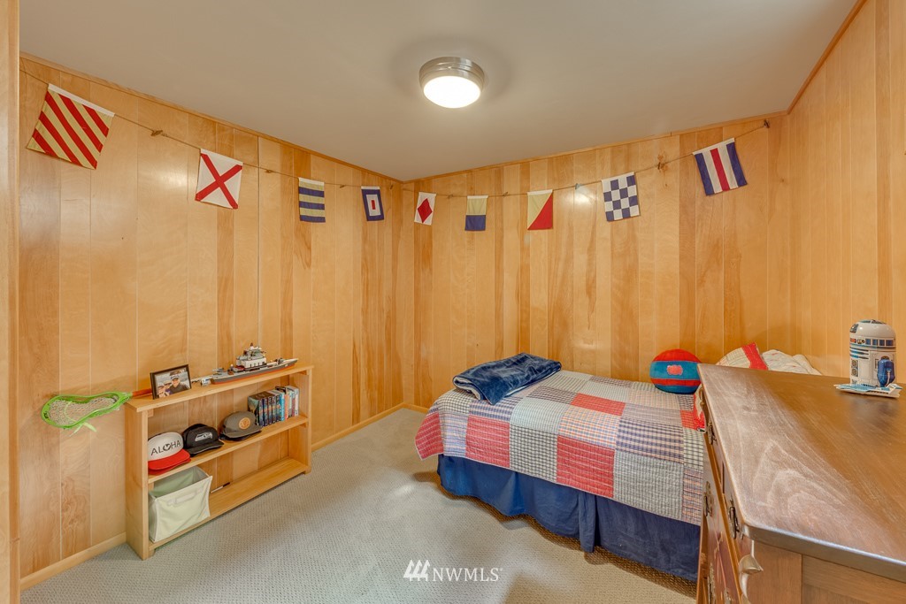 304 Heather Road Everett, WA 98203 - Photo 22 of 24 a bedroom with a bed and a chandelier