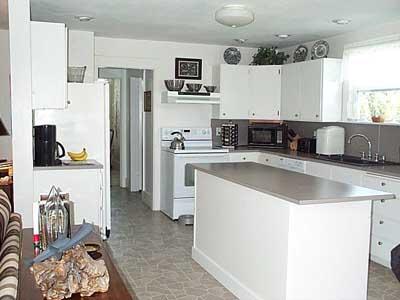 9903 Zier Road Yakima, WA 98908 - Photo 7 of 10 a kitchen with stainless steel appliances granite countertop a sink a stove a refrigerator a washer and dryer