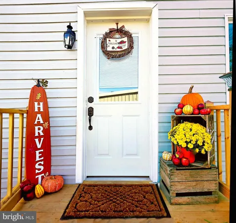 a view of a room with wooden floor and white walls