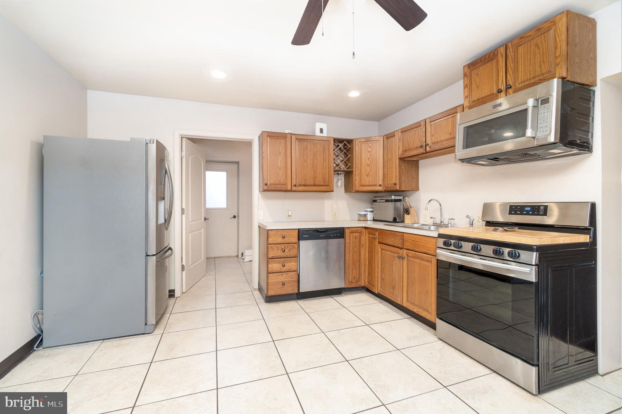 502 Celebration Hill Road Biglerville, PA 17307 - Photo 45 of 67 a kitchen with stainless steel appliances granite countertop a refrigerator and a stove top oven