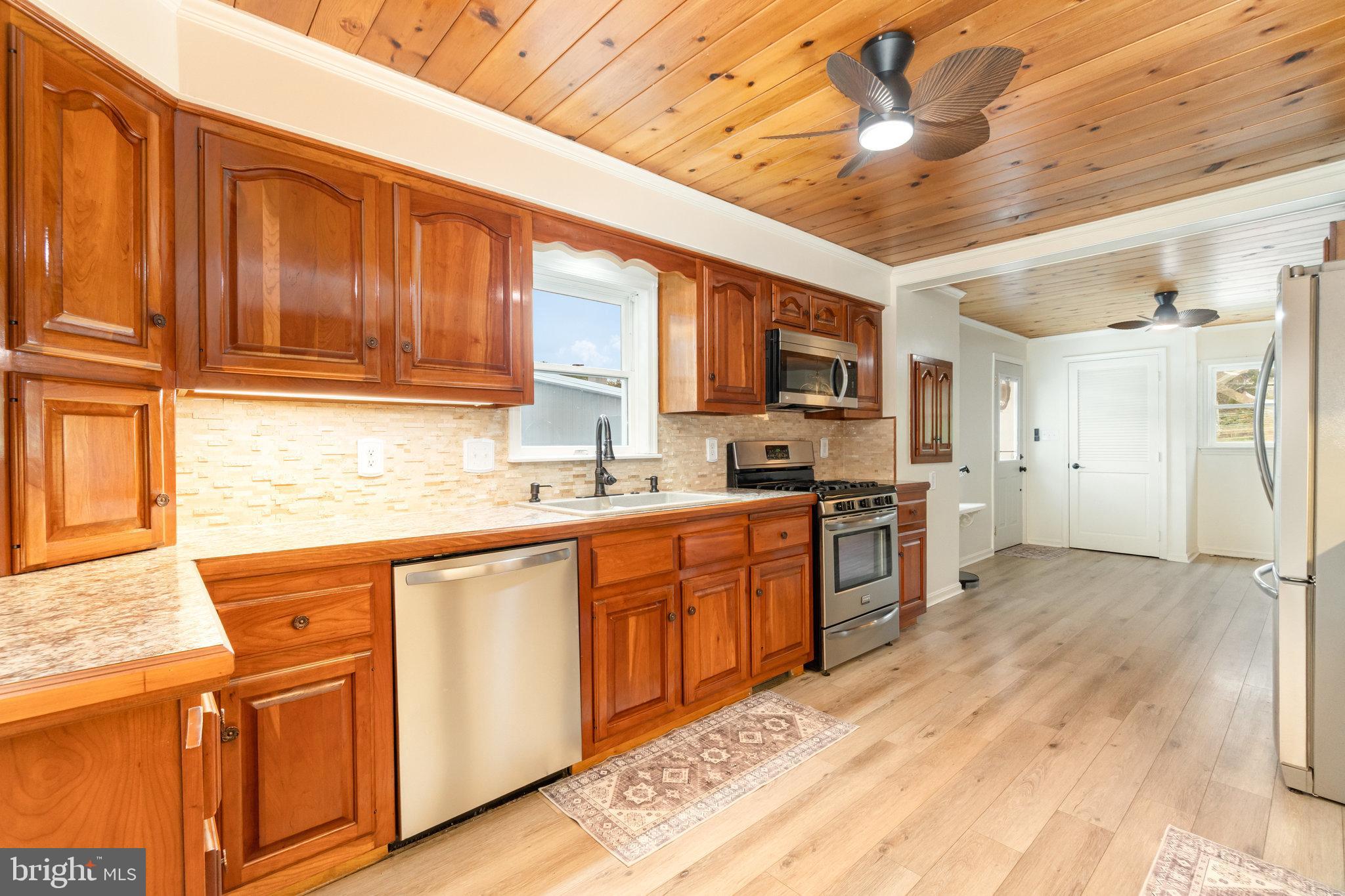 502 Celebration Hill Road Biglerville, PA 17307 - Photo 6 of 67 a kitchen with stainless steel appliances granite countertop a refrigerator and wooden cabinets