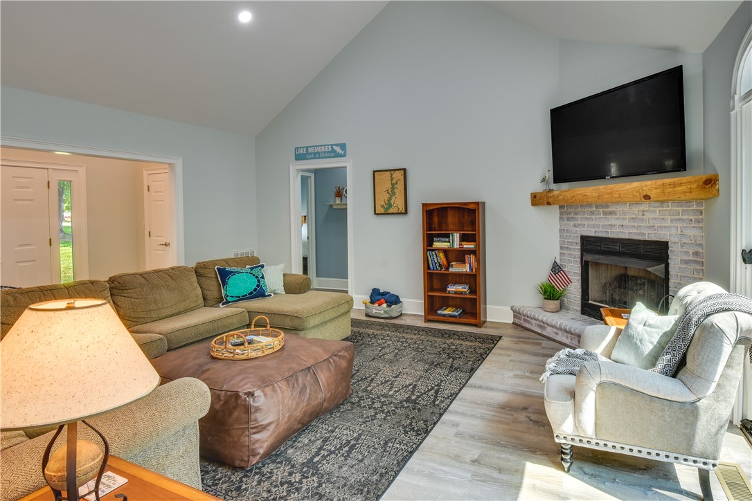 206 Petty Road Seneca, SC 29672 - Photo 15 of 48 Gather around the brick fireplace in this living room with high ceilings.
