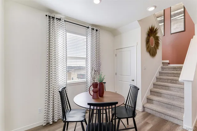 a view of a dining room with furniture and wooden floor