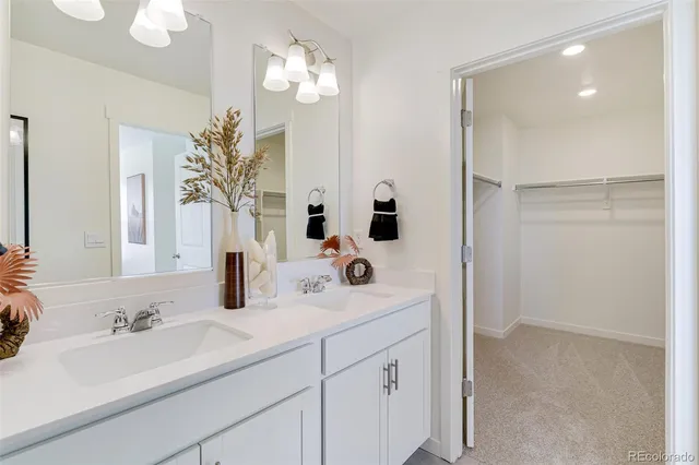 a bathroom with a sink double vanity and a mirror