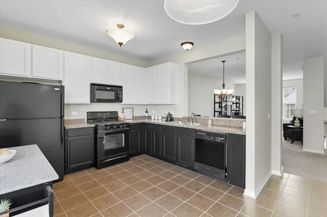 a kitchen with a sink stainless steel appliances and cabinets