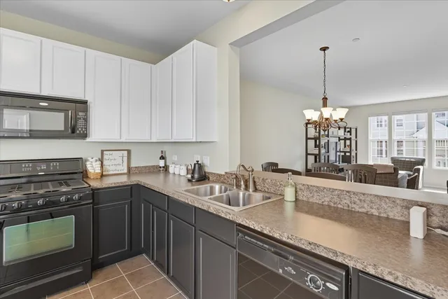 a kitchen with stainless steel appliances granite countertop a sink a stove and oven
