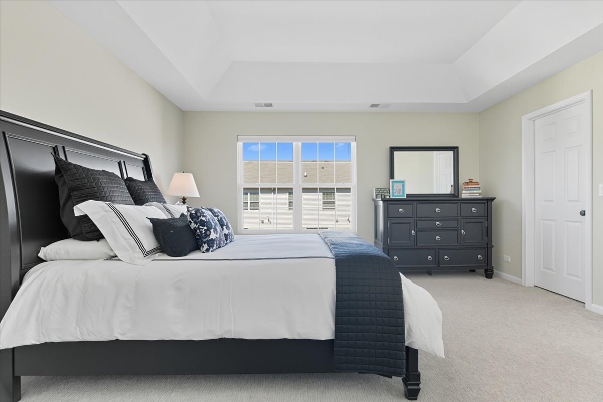 3077 Nicklaus Lane Wadsworth, IL 60083 - Photo 19 of 28 a bedroom with a bed and a dresser