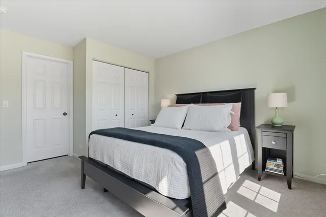 a bedroom with a bed and a table