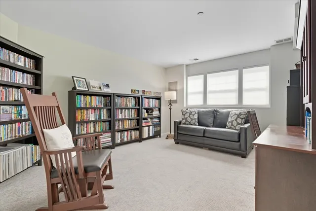 a living room with a couch and a book shelf
