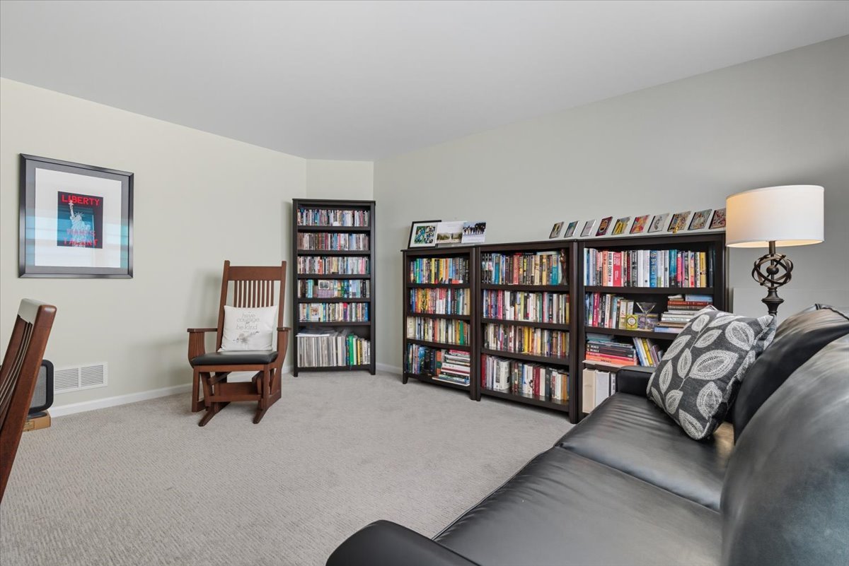 3077 Nicklaus Lane Wadsworth, IL 60083 - Photo 26 of 28 a living room with furniture a book shelf and a book shelf